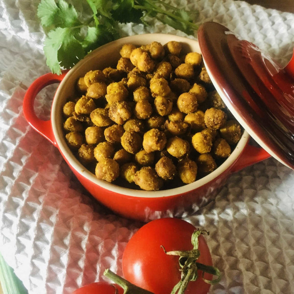 Indian style roasted chickpeas in a red ceramic pot